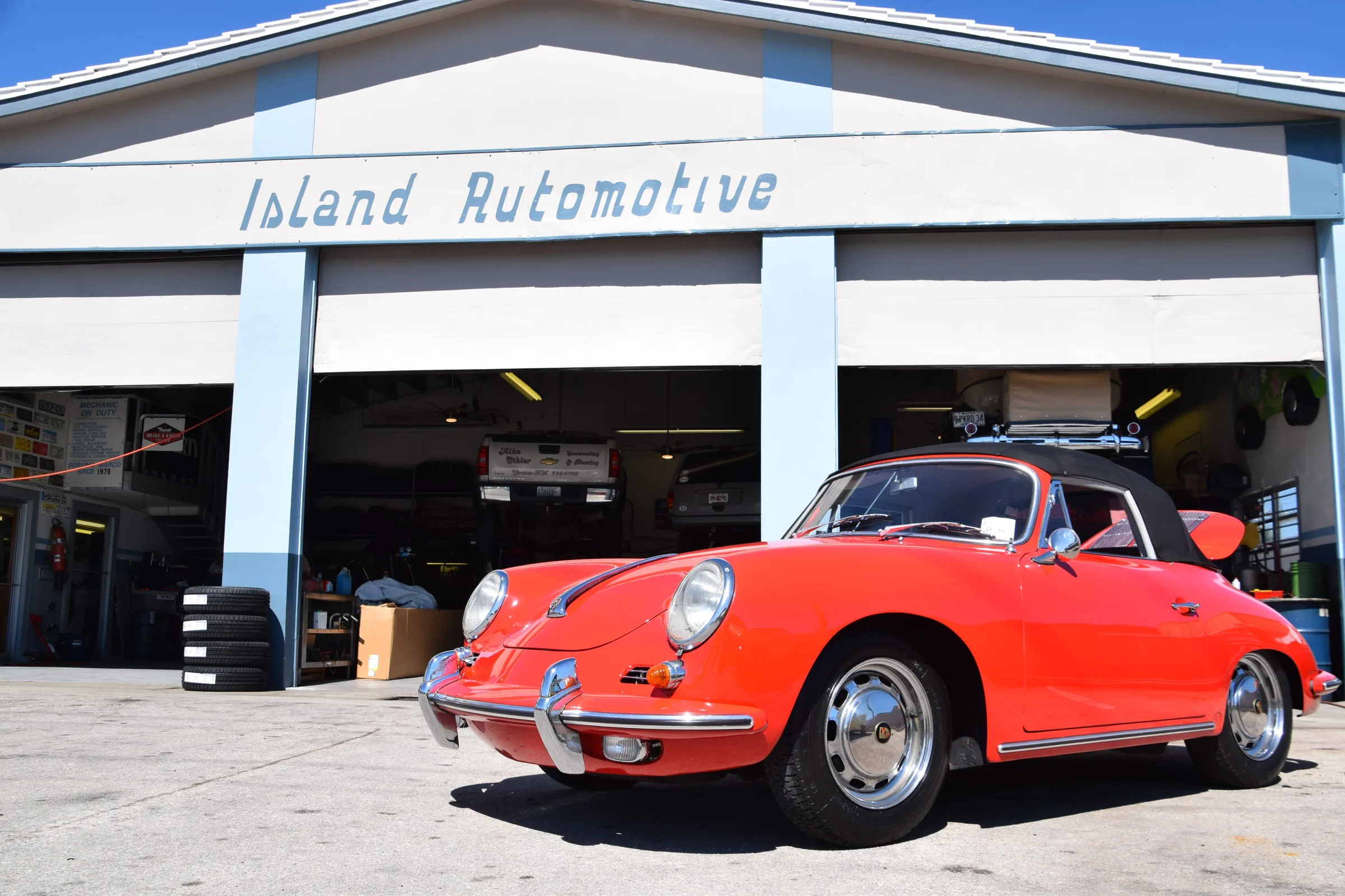Red Porsche 356 in front of the Island Automotive shop on Elkcam Circle