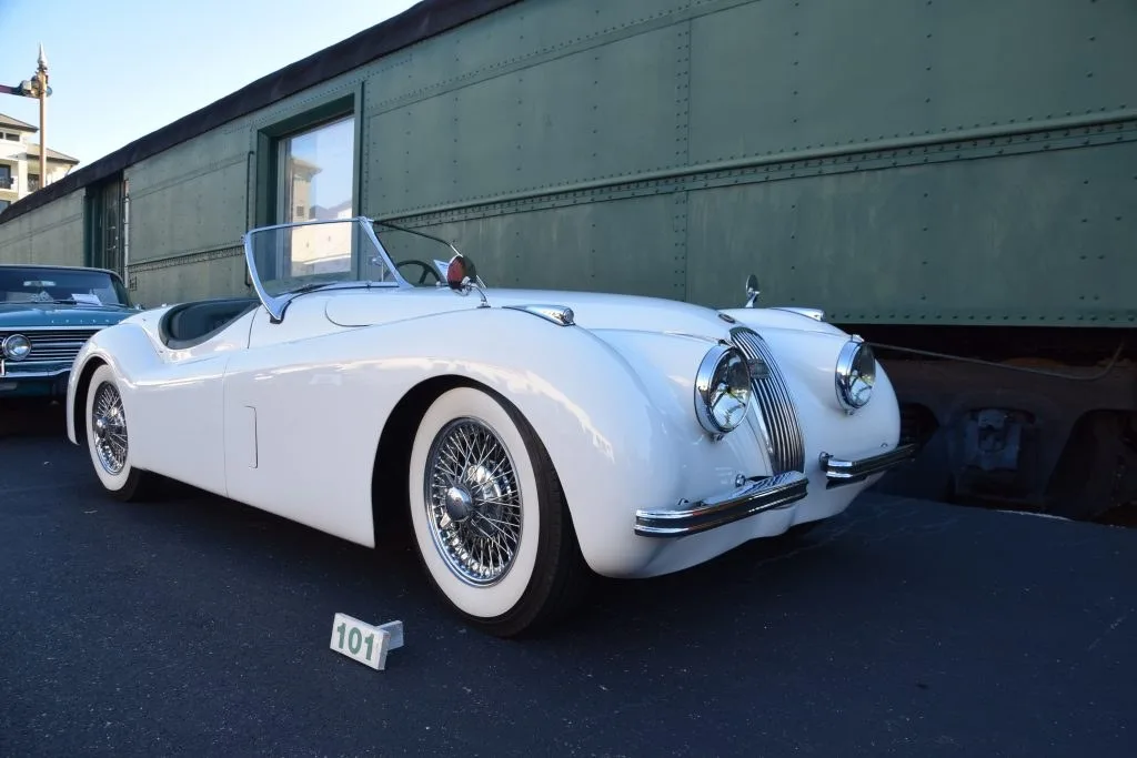 White Jaguar roadster at a car show