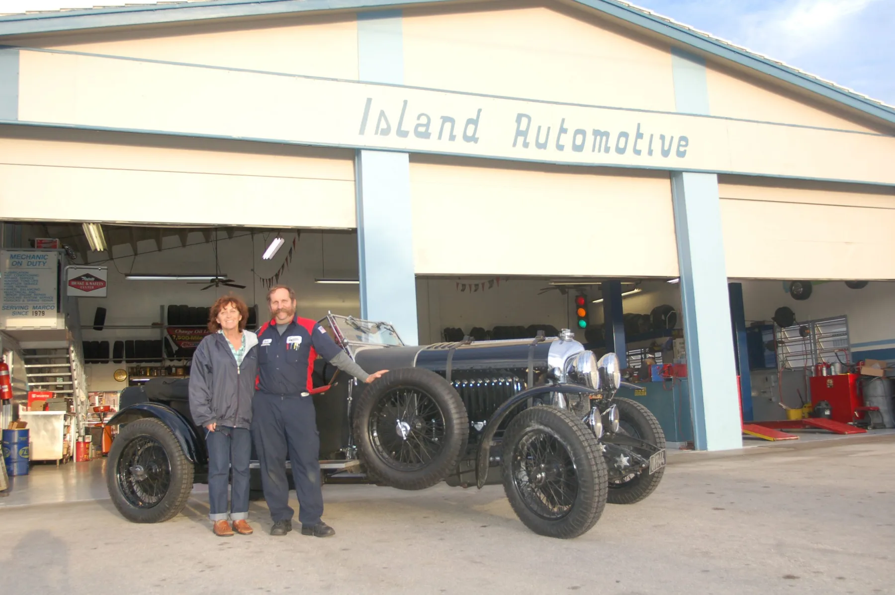 Keith and Vicki Pershing standing with a 1929 Bentley